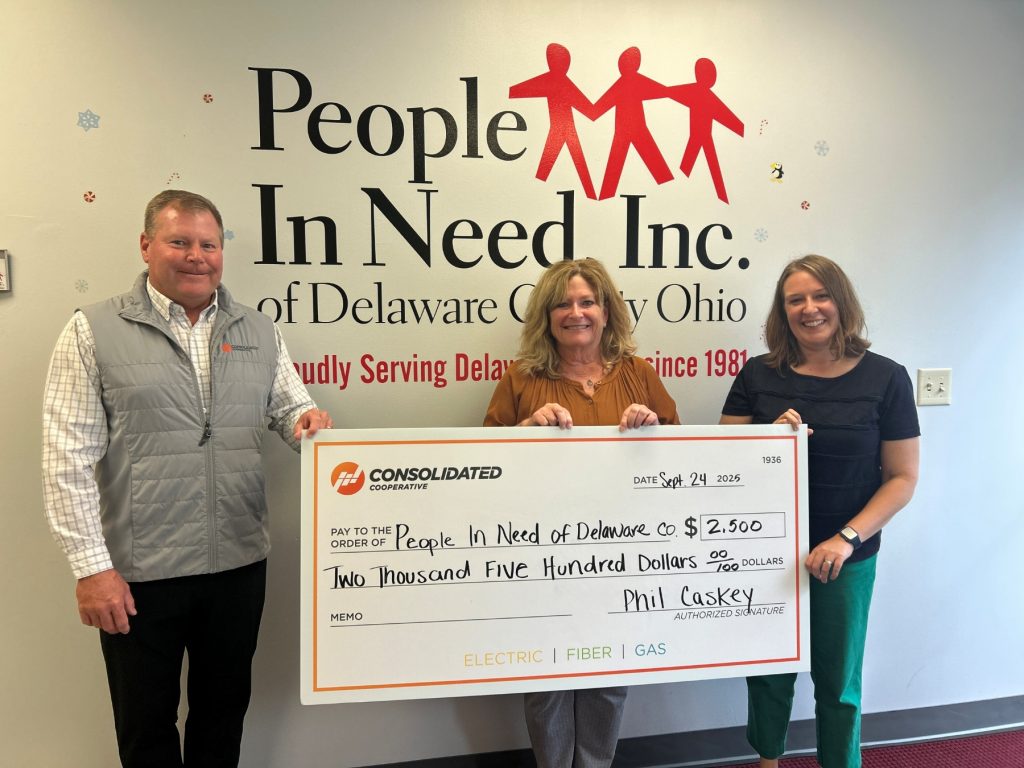 Consolidated Employees with the People In Need team holding a check for $2,500