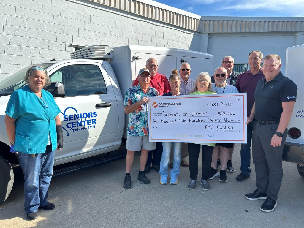 Consolidated Employees with the Seniors on Center Team holding a check for $2,500