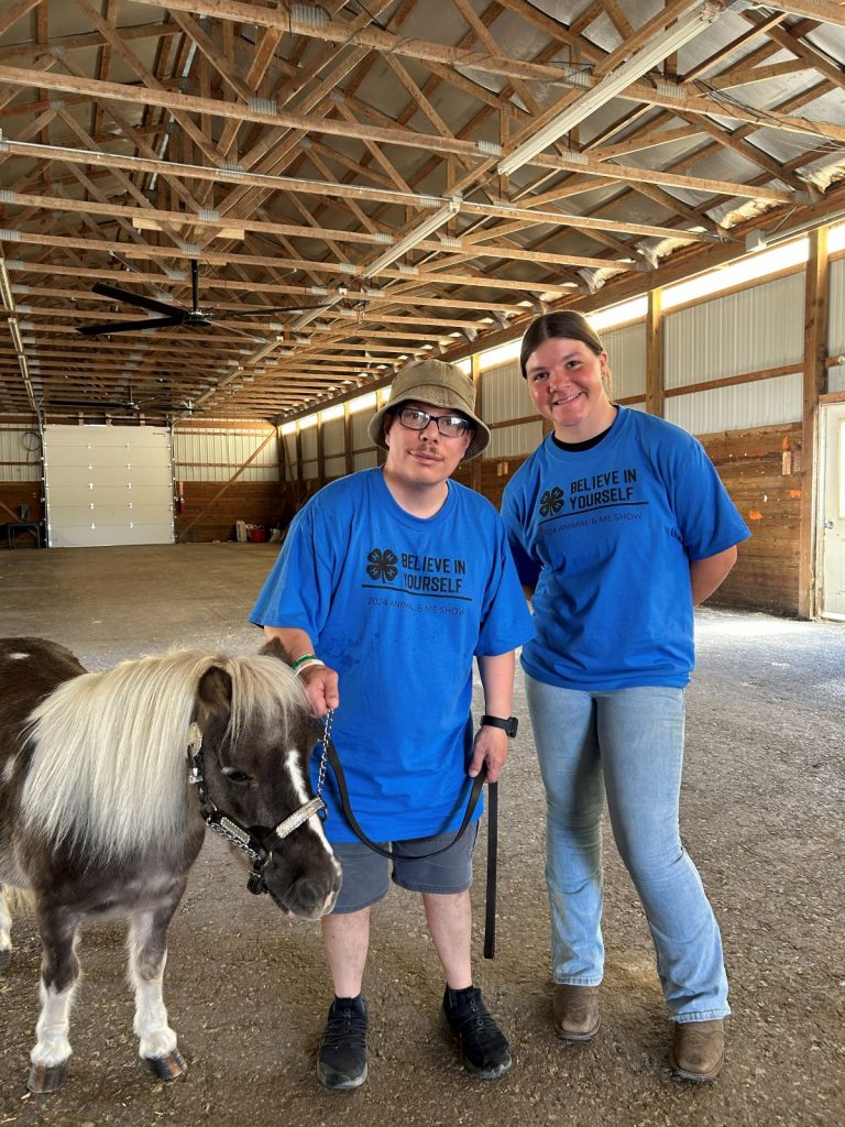 Two participants in the animal and me show from the Delaware County Fair smile with their miniature horse