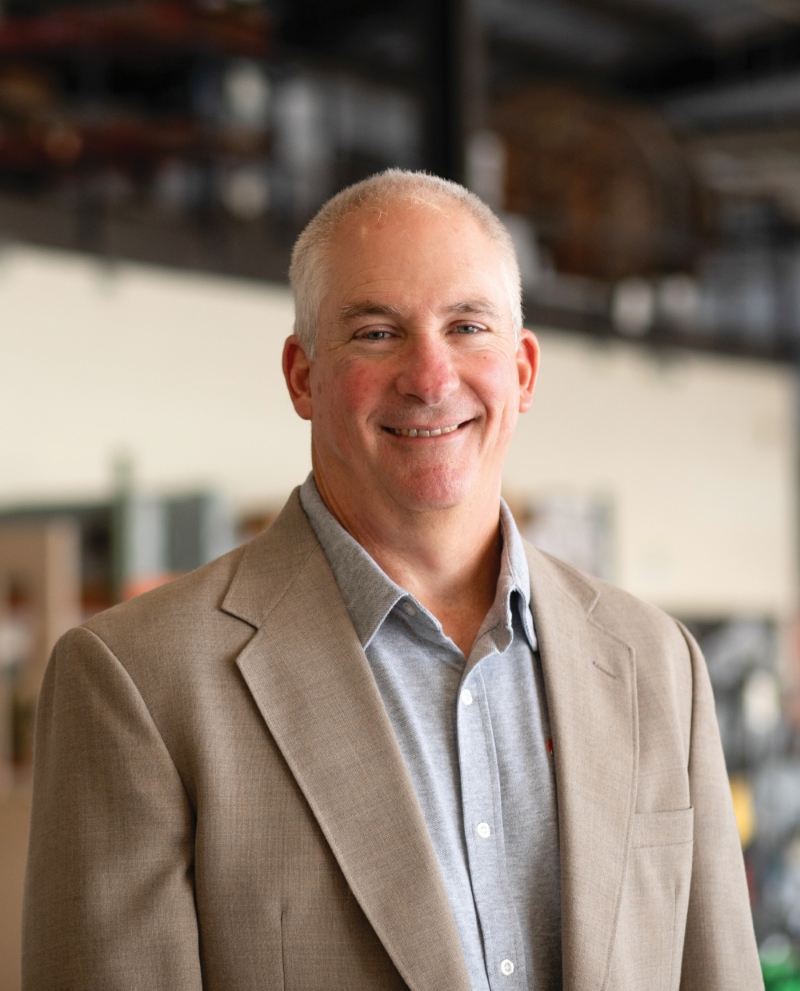 A headshot of Phil Caskey Smiling