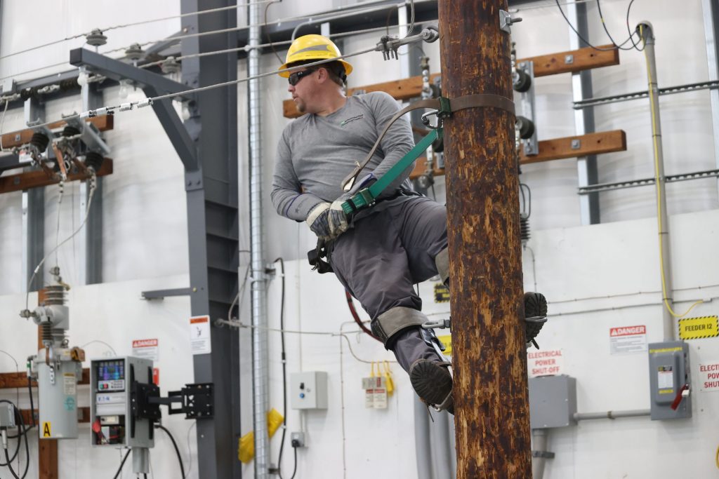 A lineworker up on a pole in COLT's facility